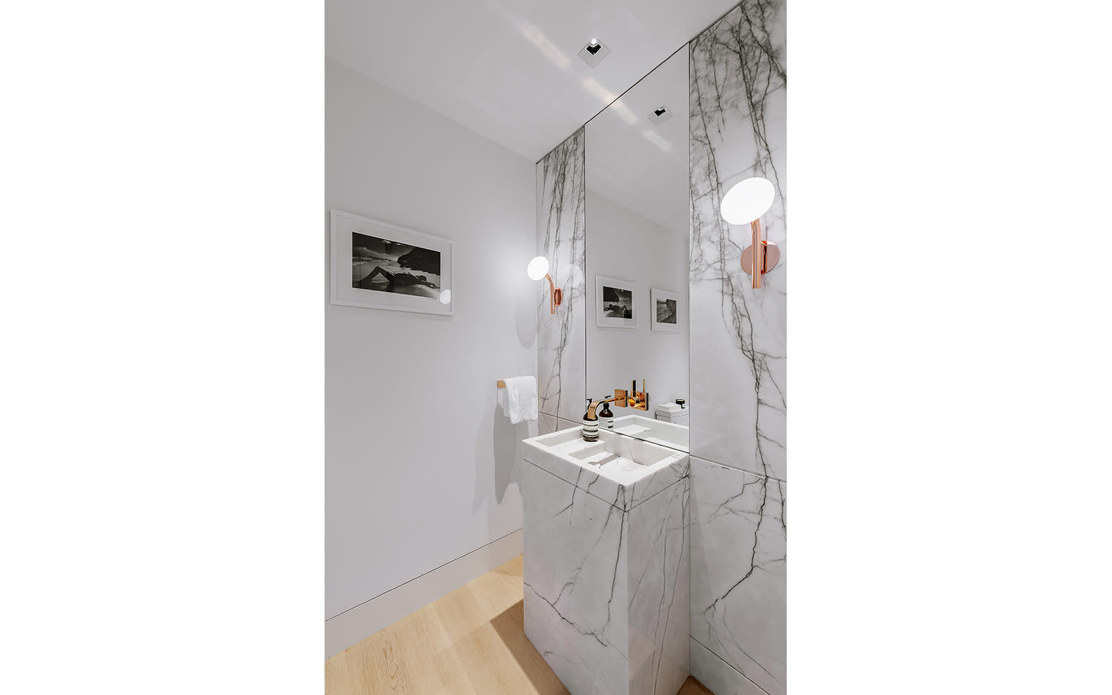 powder room with decorative rose gold scones inside a los angeles condominium