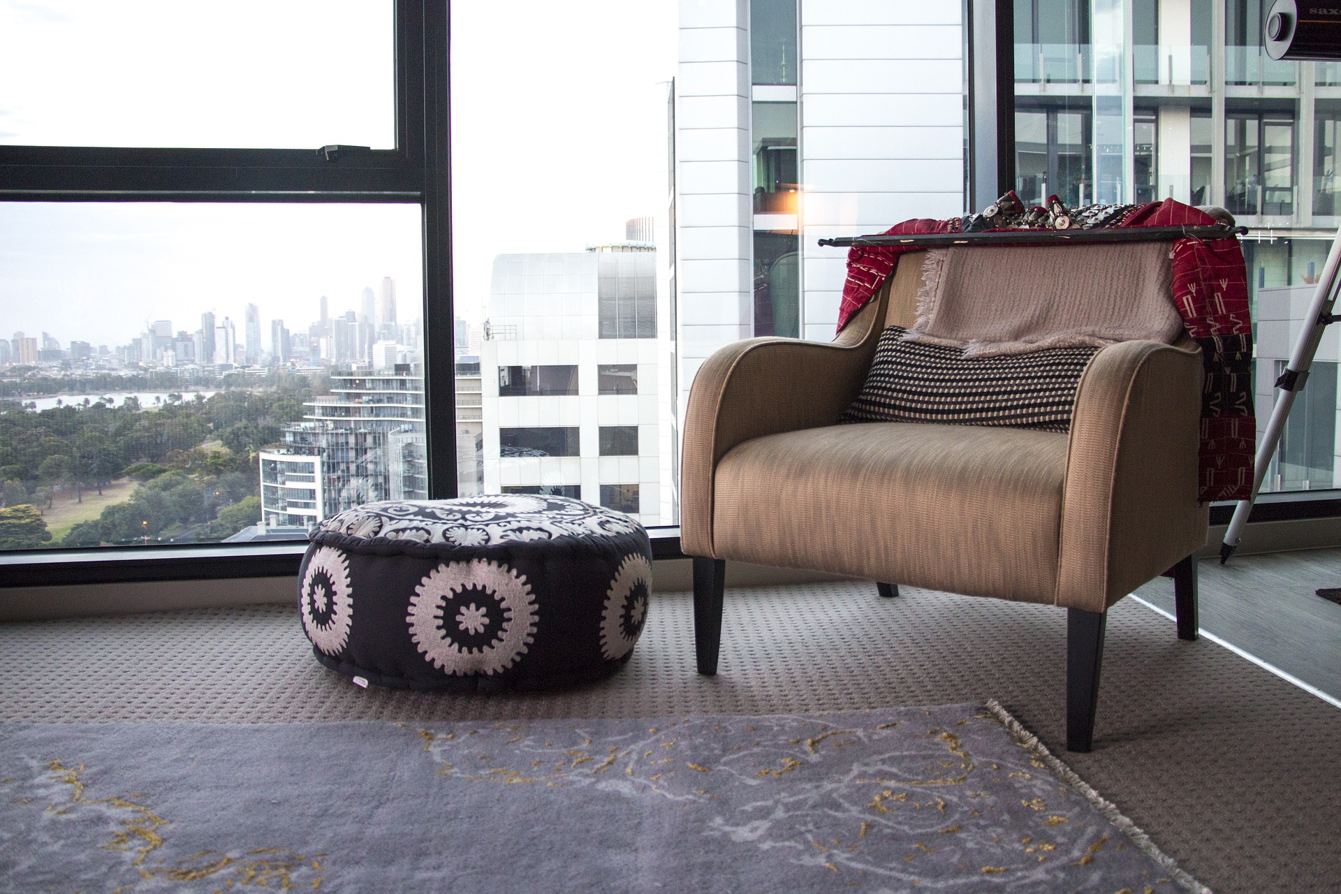 luxury condominium living room in australia with walls of glass looking at skyline