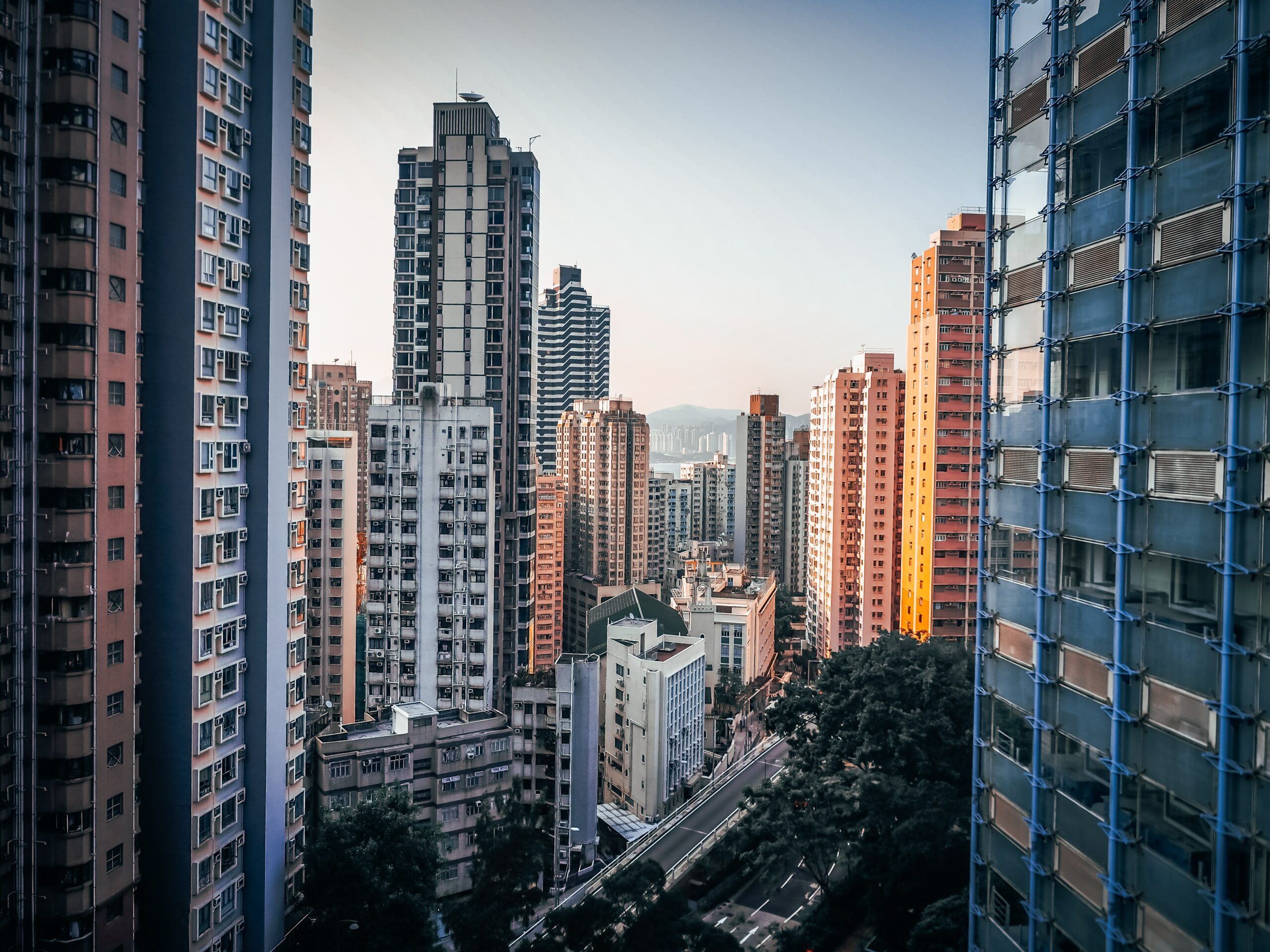 looking down a corridor of apartment towers in hong kong