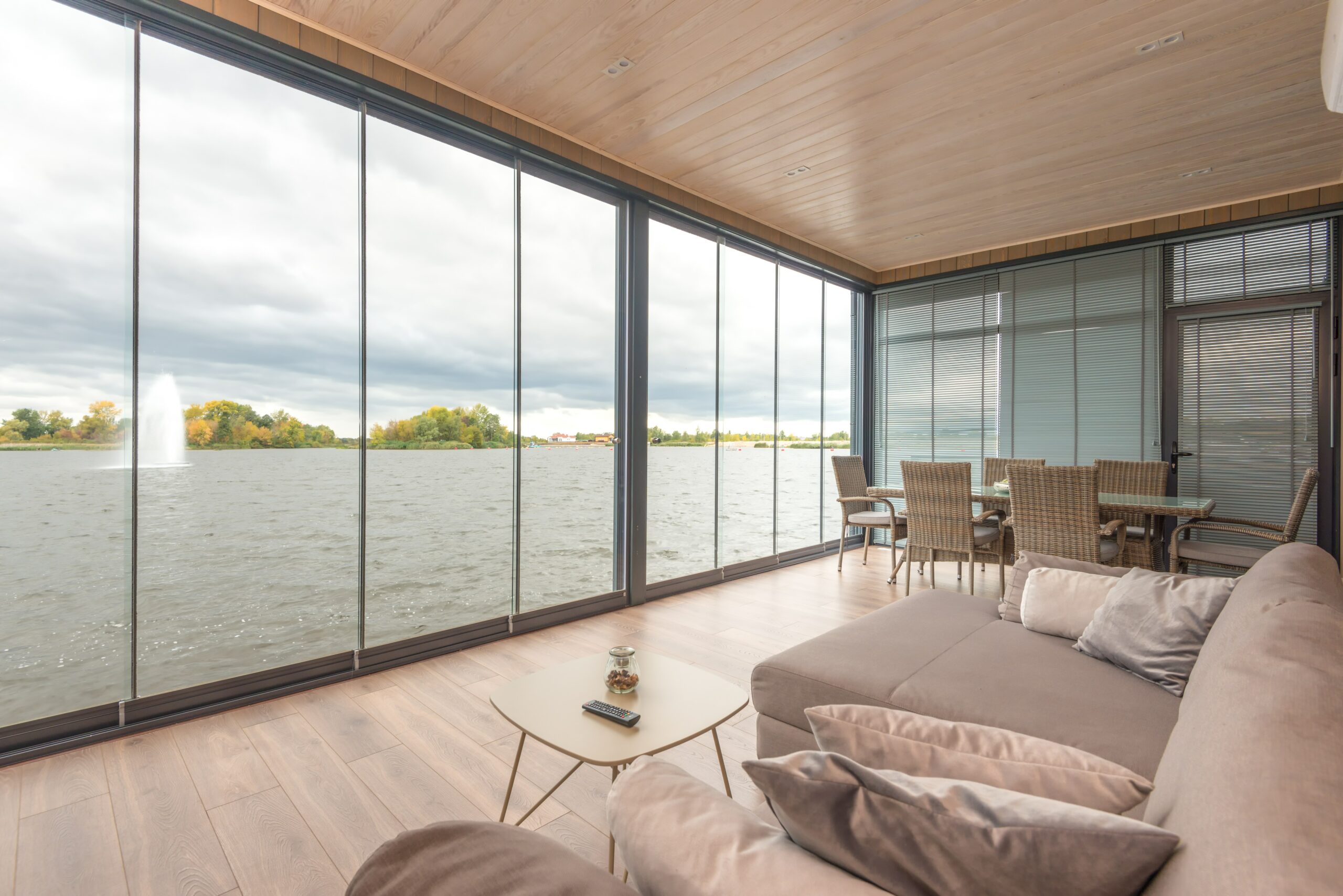 condo with walls of glass looking out onto water