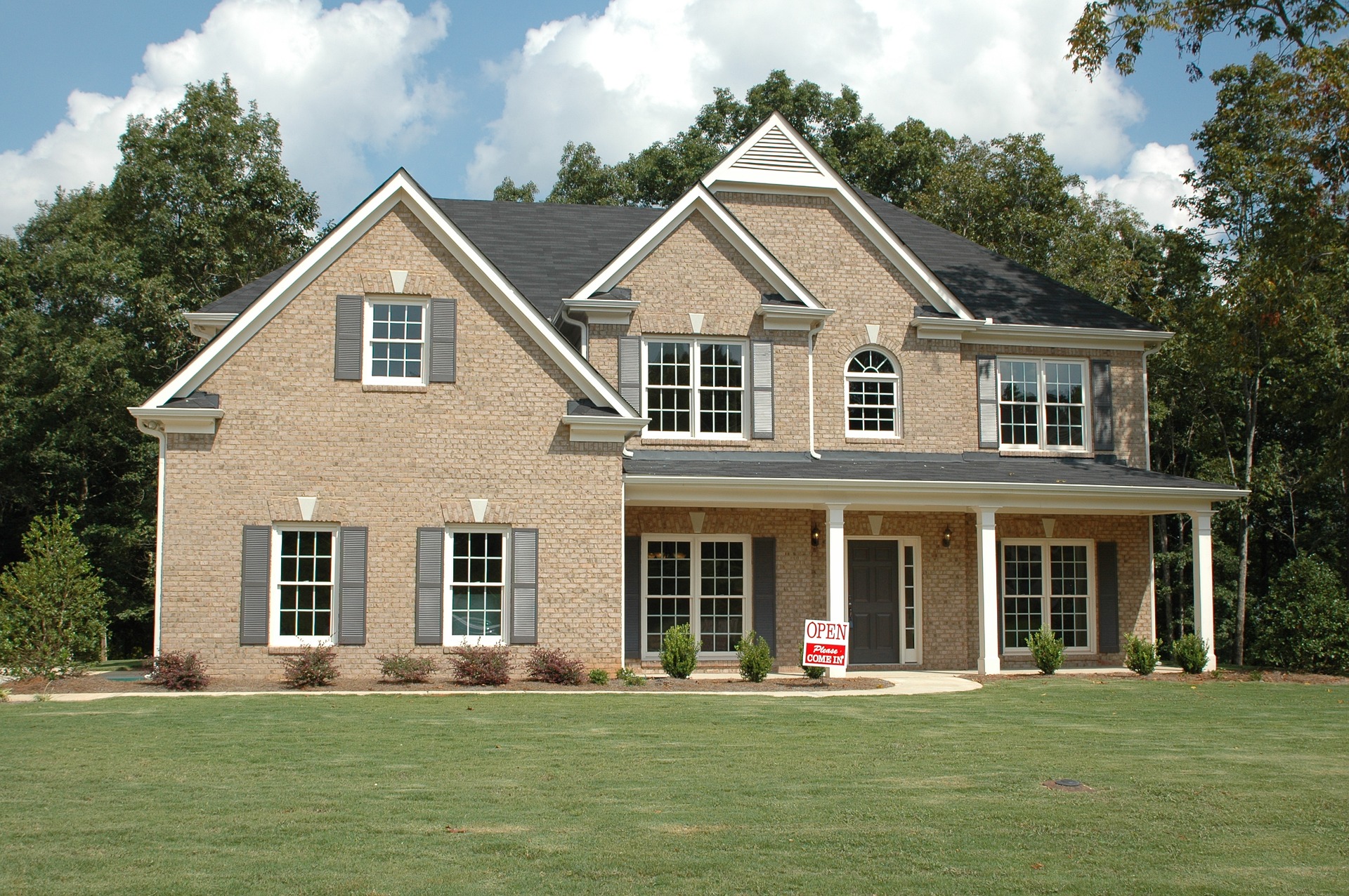 newly built home with a for sale sign out front