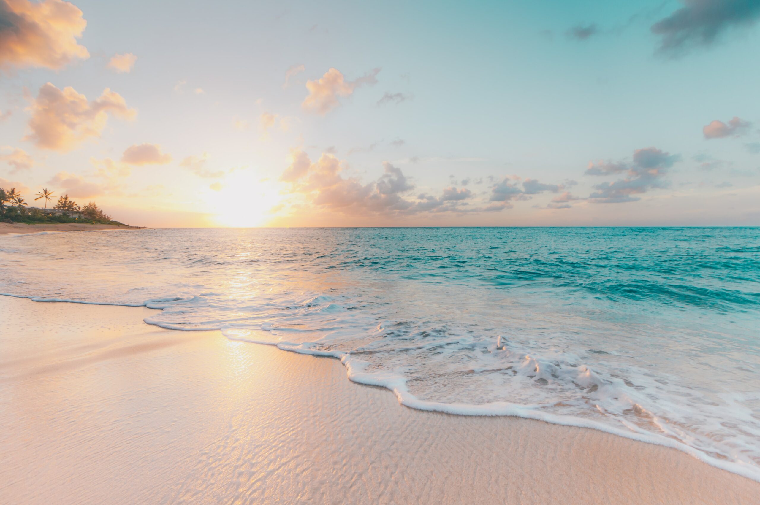hawaii sunset over water and sand
