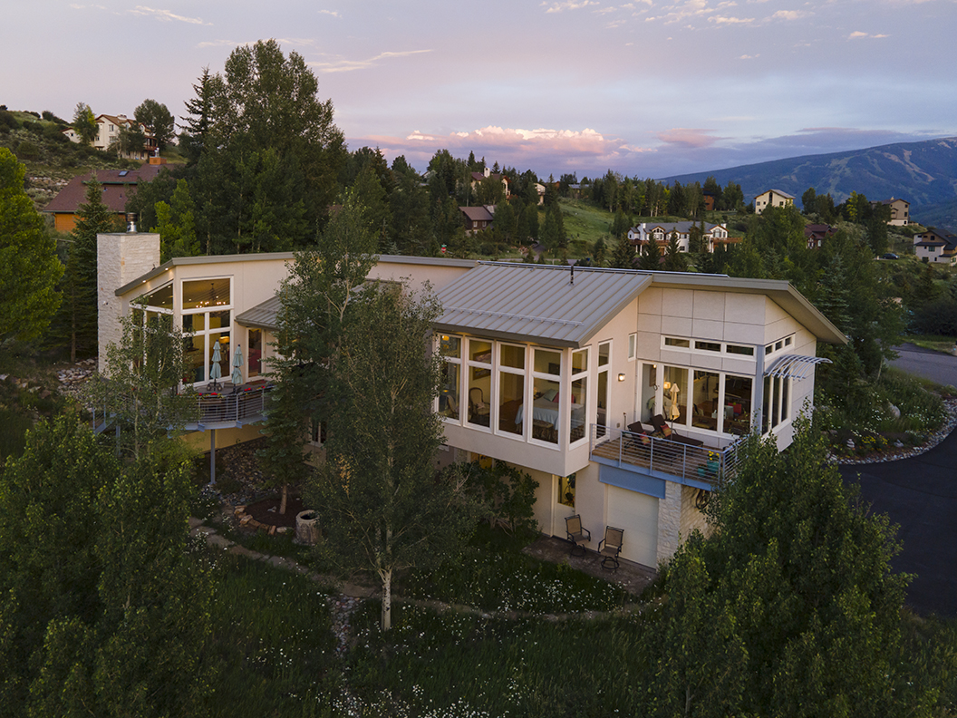 exterior view of the home with the sunset in the background