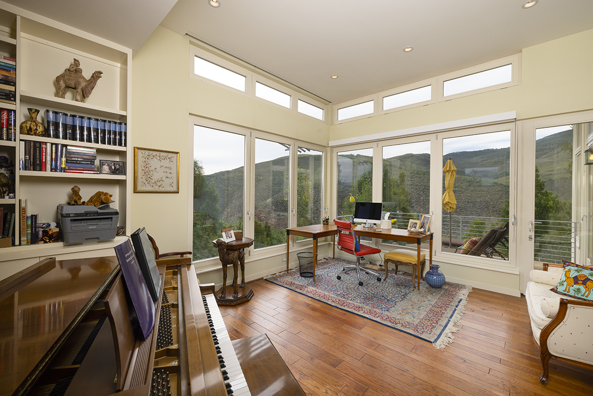 Interior view of the home with a piano and views of the