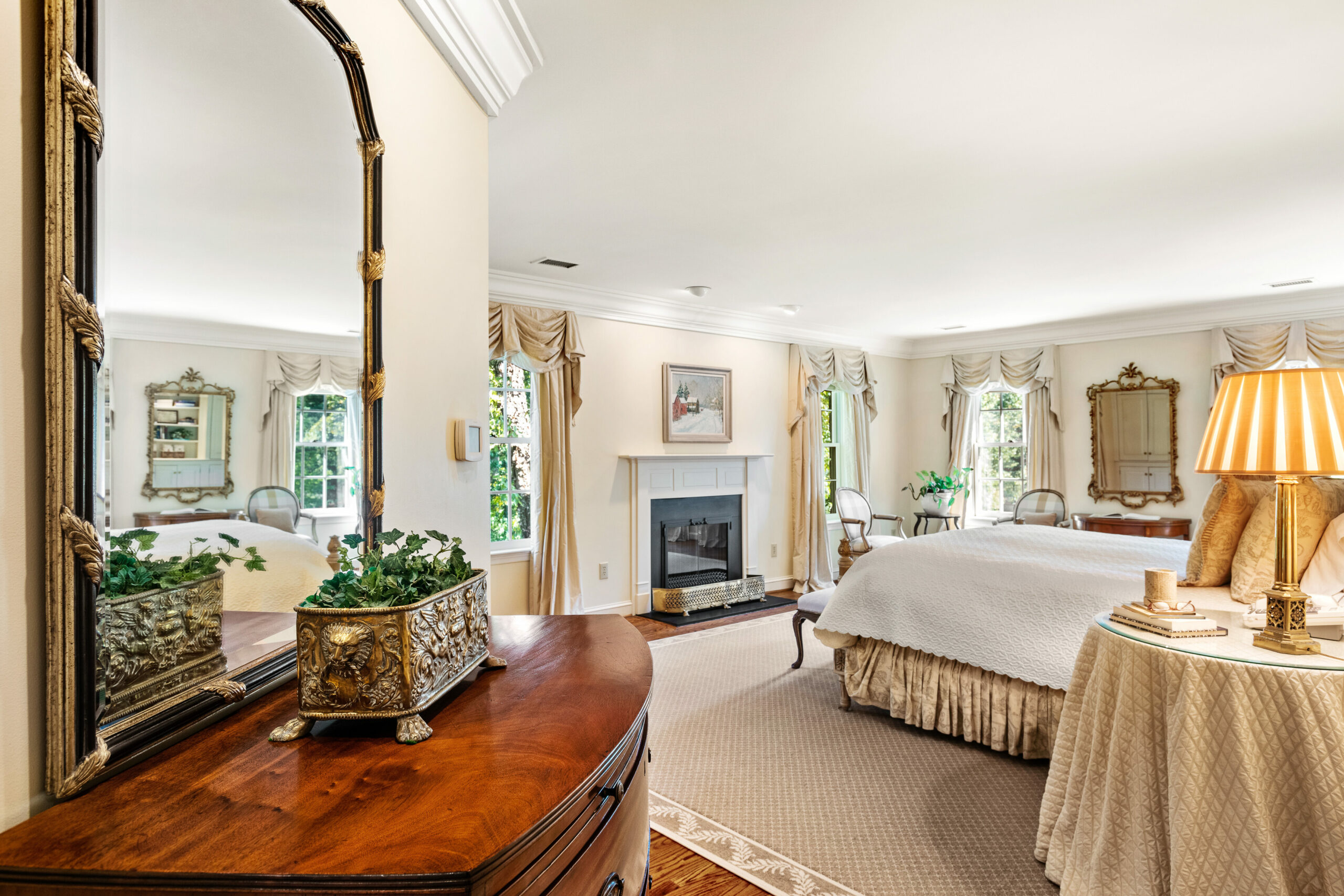 Interior view of a bedroom with white walls and a fireplace