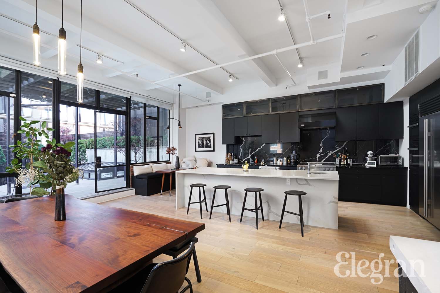 Interior view of the home's kitchen with dark marble and open floorplan.